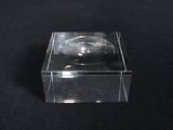 a close up of a clear box with a watch inside of it