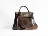 a brown and brown leather handbag on a white background