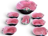 pink and black ceramic bowls and spoons with pink flowers on them