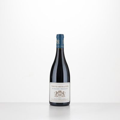 a bottle of red wine sitting on top of a table