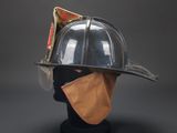 silver fireman ' s helmet on a mannequin head with a bandana