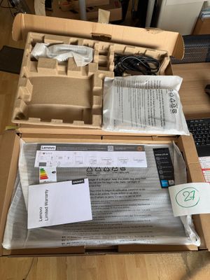 a box with a keyboard, mouse, and other items in it