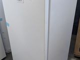 two white refrigerators sitting next to each other on the floor