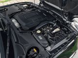 the engine of a car with its hood open on the street