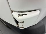 a close up of a white toilet with a rusted door handle