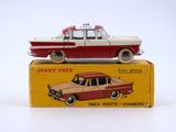 a red and white toy car sitting on top of a box