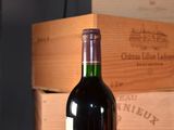 a bottle of wine sitting on a table next to a box of wine