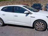 a white car that is parked in a parking lot