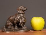 a statue of a dog and an apple on a table