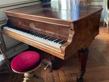 a grand piano in the corner of a room