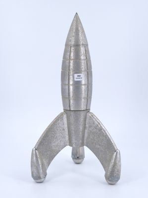 silver metal model of a space rocket on a white background