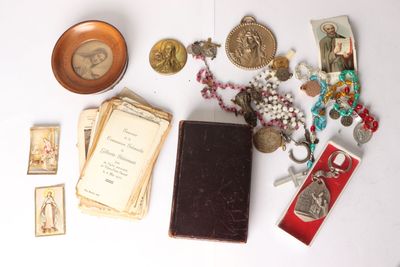 a table with a lot of items on it including a book and a medal