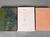 three books sitting on a table next to each other on top of a table
