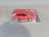 a red toy car that is in a clear box