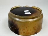 a brown and black box with a tag on it