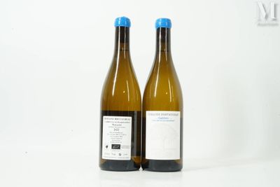two bottles of wine sitting next to each other on a table