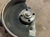someone is using a circular cutter to cut a piece of wood