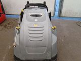 an image of a lawn mower parked in a garage