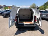 a white van with its door open in a parking lot