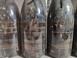 several bottles of wine are lined up on a shelf