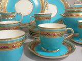 many cups and saucers that are sitting on a table