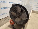 the fan is sitting on the cart in front of the wall