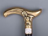 a close up of a gold colored cane with a clock on it