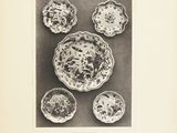 an old black and white photo of a plate and bowls of food