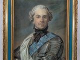 portrait of a man in armor in a blue and gold frame