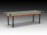 une table avec un plateau en verre et des pieds en métal