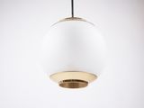 a white and gold pendant light hanging from a ceiling