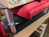 a box sitting on top of a red couch in a room