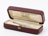 a small box with a pen in it on a white surface