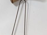 a wooden object hanging on the wall next to a metal object