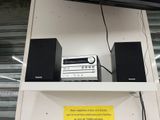 a shelf with speakers and a radio on top of it