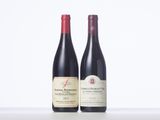 two bottles of red wine sitting next to each other on a table