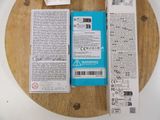 a box of wii remotes sitting on top of a wooden table