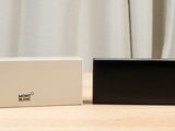two black and white boxes sitting on top of a wooden table