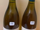 two bottles of wine that are sitting on a table