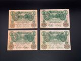 three old german bank notes on a black surface