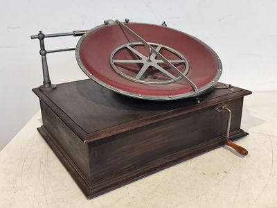 une vieille boîte en bois posée sur une table, avec une assiette rouge dessus