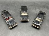 three old model cars that are sitting on a table