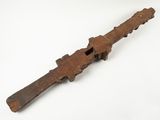 an old wooden tool with a long handle on a white surface