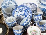 a lot of blue and white dishes and cups on the table