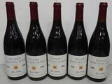 six bottles of wine are lined up on a table