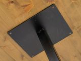 a close up of a black metal pole on a wooden table