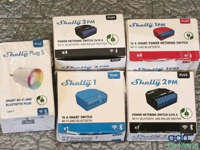 several boxes of electronics sitting on top of a table next to each other