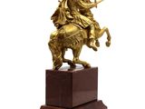 statue of a man on a horse with a sword on a marble base