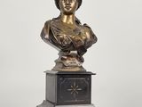 a bronze busturine of a woman on a pedestal