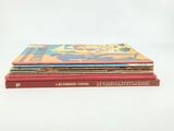 several children ' s books stacked on top of each other on a white surface